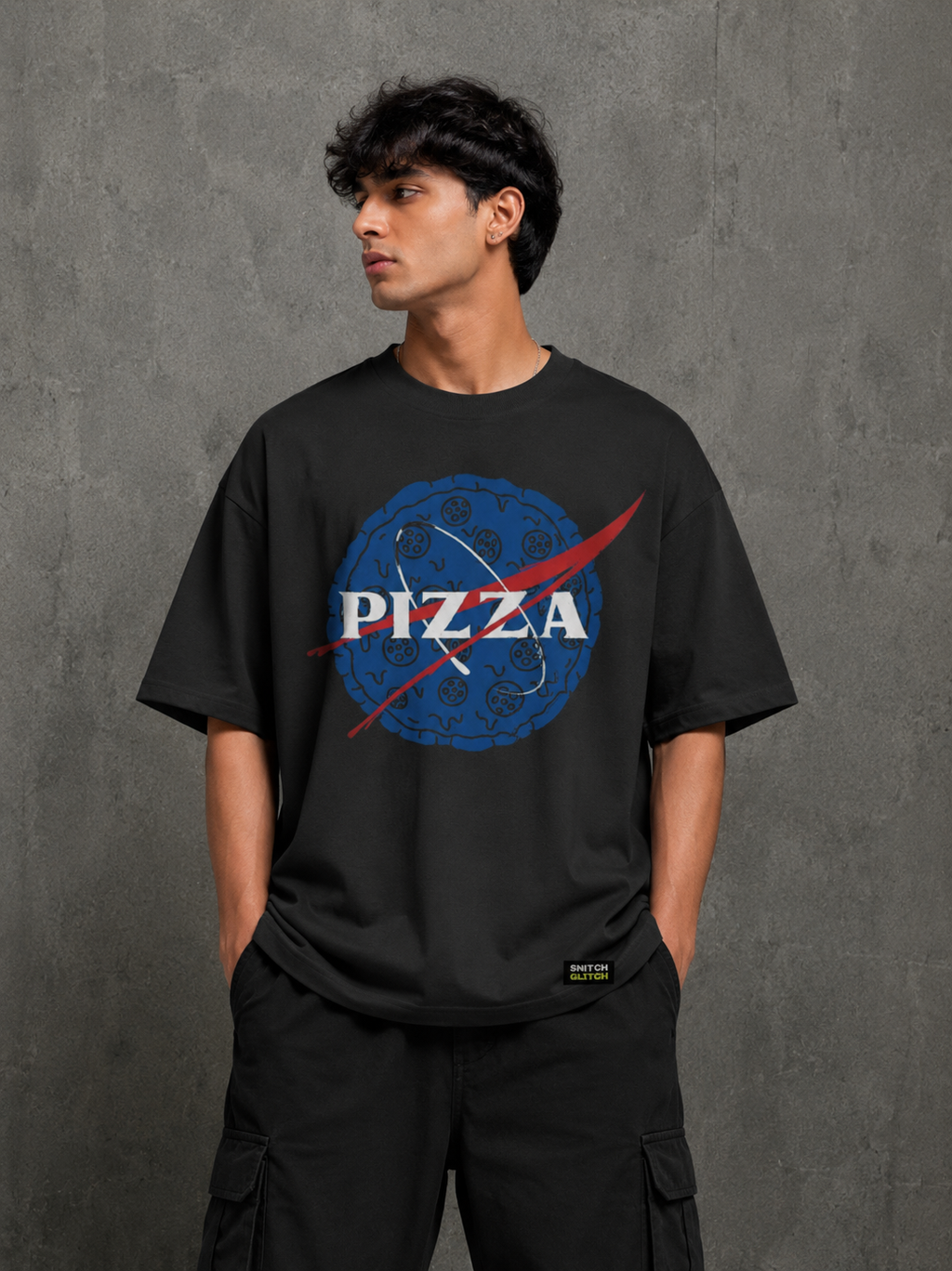 Model wearing black Pizza Glitch oversized t-shirt with bold pizza graphic front print by Snitch Glitch