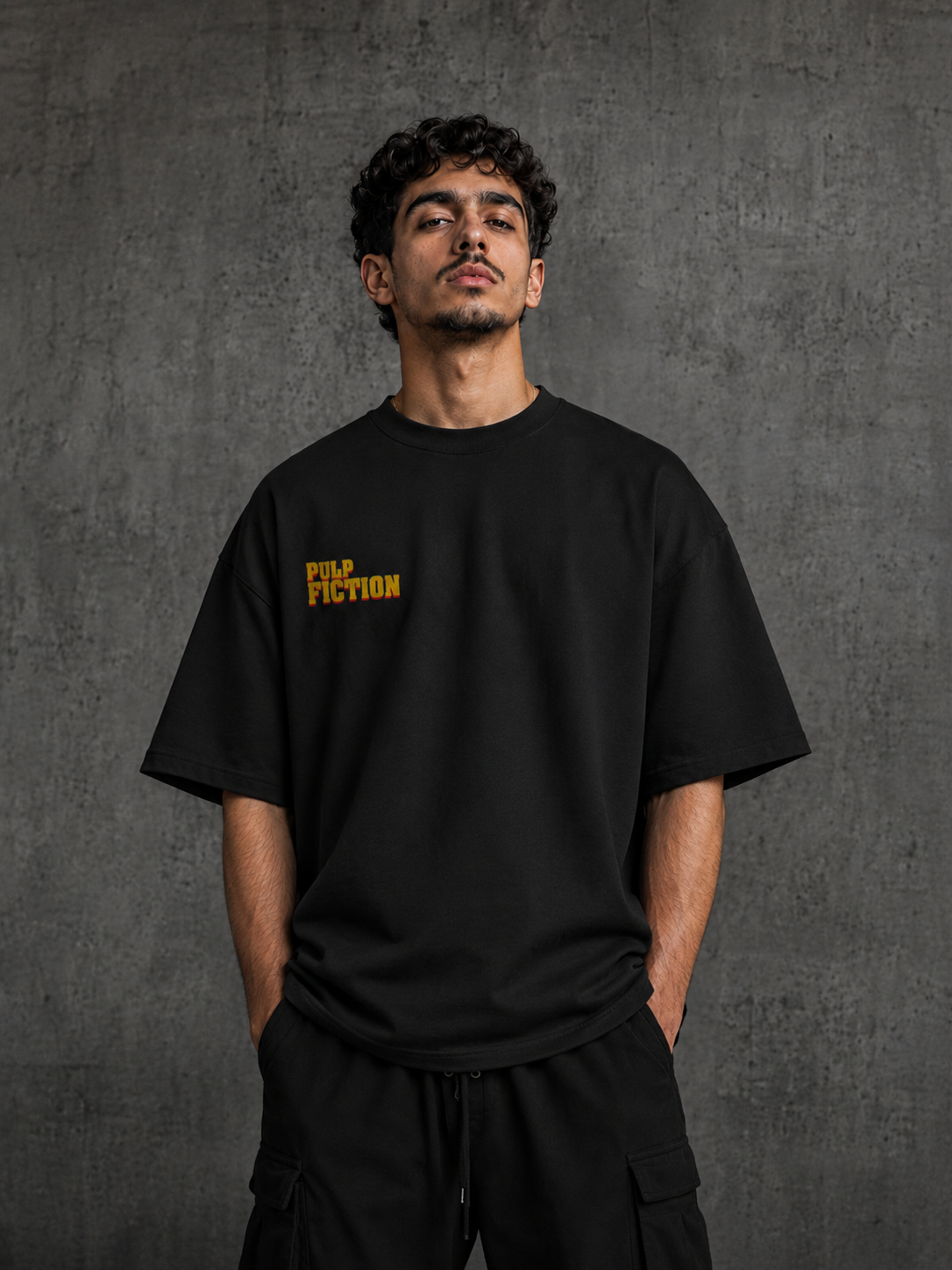 Model wearing black Pulp Fiction oversized t-shirt with bold retro movie back artwork by Snitch Glitch